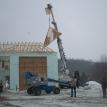 Setting Trusses with our digger derrick bucket truck